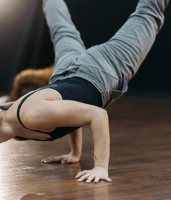 Athlete in a powerful yoga pose, demonstrating balance and strength.